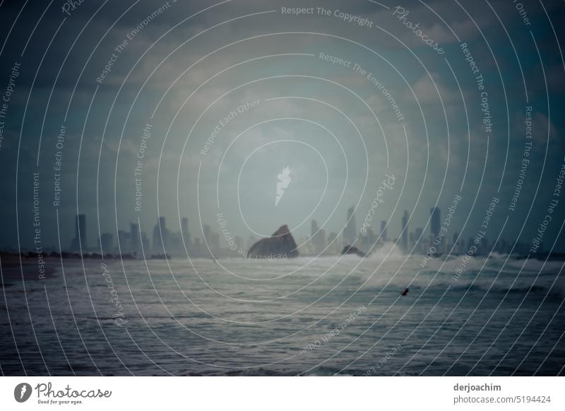 The Big Rock in the sea ,against the background of Surfers Paradise, with swimmer. Stone Water Blue coast Waves Deserted Sky Summer Day Beautiful weather