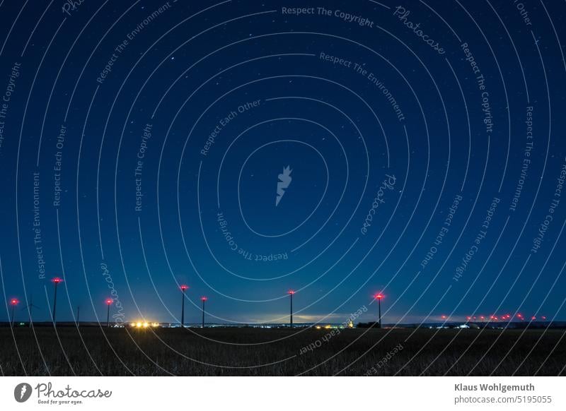 Night over the small town Friedland in Mecklenburg-Vorpommern, many wind turbines can be seen in the surroundings, stars shine in the sky Night sky Night shot