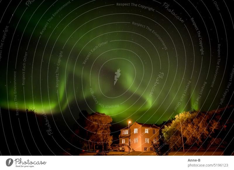 Aurora Borealis , beautiful green sky behind guest house in Scandinavia, Iceland Green billowing Mystic solar wind aurora borealis cot Window inn East Iceland