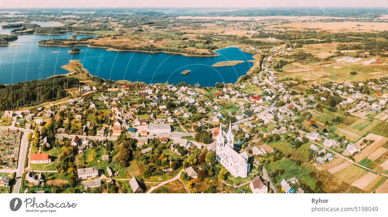 Slobodka, Braslaw District, Vitebsk Voblast, Belarus. Aerial View Of Potsekh Lake Near Slobodka Village. Church of Divine Providence. Panorama Braslau Braslav