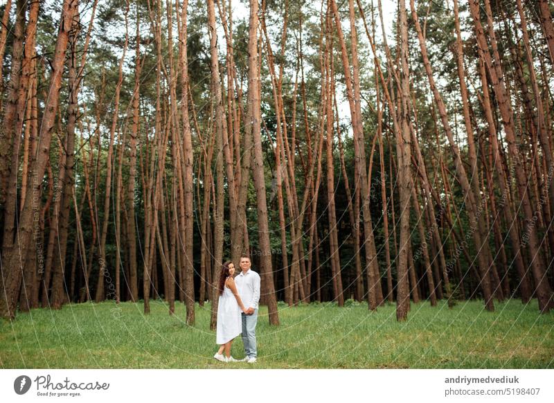 full height portrait of young couple in love having fun and enjoying the beautiful forest on summer sunny day nature male together outdoors happy happiness