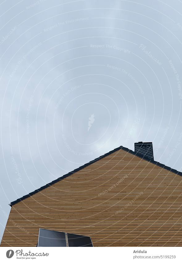 old house with new insulating wood paneling, two solar panels and cloud sky Solar panels House (Residential Structure) pediment Wood refurbishment Insulation