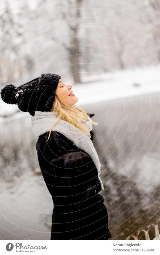 Young woman n warm clothes enjoying in snow beauty model girl person young winter nature outdoor happy white frost season day emotions coat adult wear air