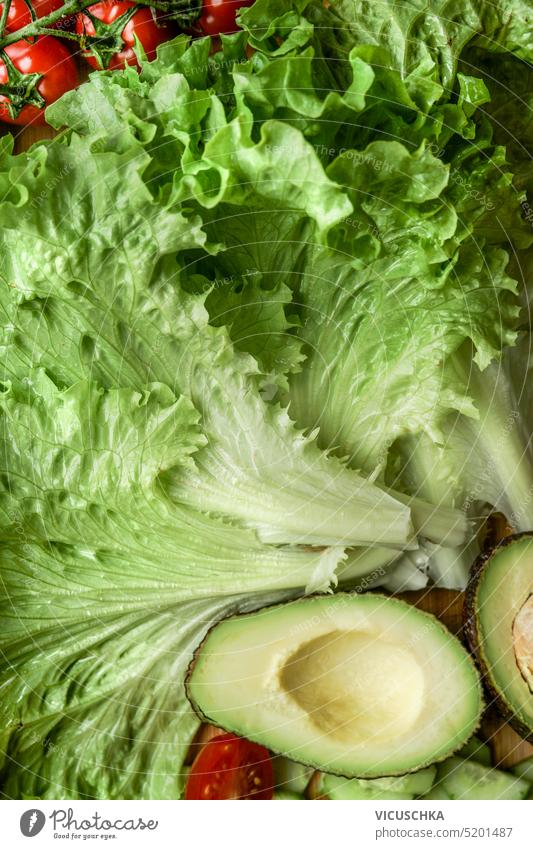 Close up of salad ingredients: lettuce, avocado, tomatoes. Healthy food and dieting concept close up healthy food close-up fresh green leaf organic raw