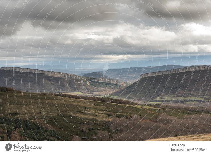 Landscape with plateaus and cloudy sky in winter Winter Hill Forest Structures and shapes Calm Peaceful Nature mountain Day daylight Clouds Sky Grass trees