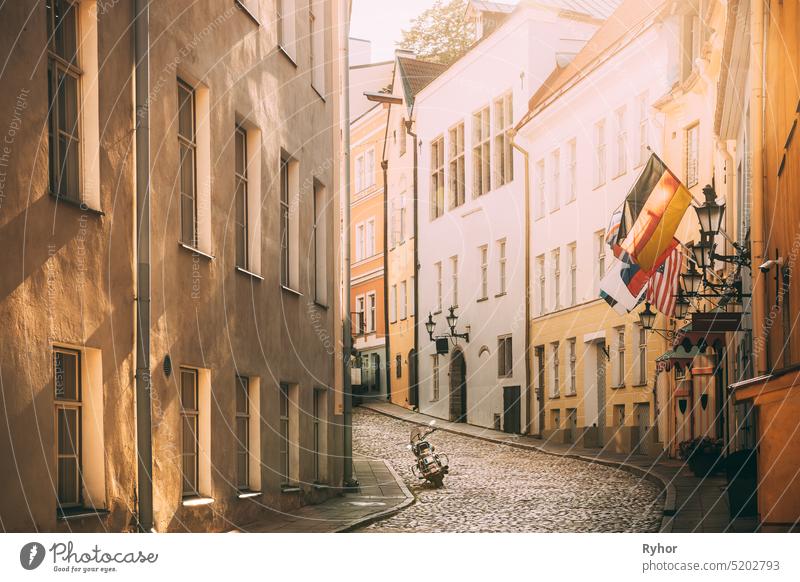 Tallinn, Estonia. Empty Puhavaimu Street In Old Town During Sunset. Motorcycle Parked On Old Street tallinn estonia narrow street old town baltic beautiful