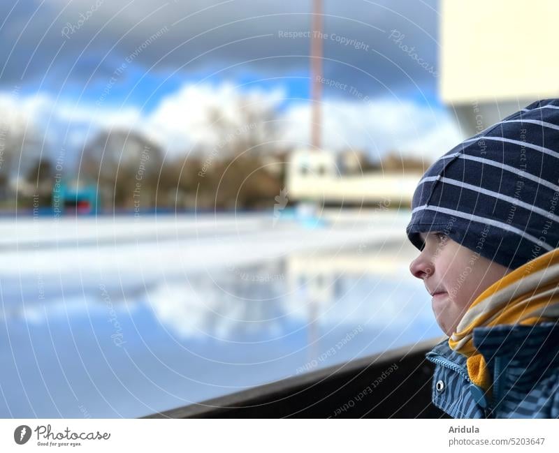 Child looks waiting at empty skating rink Ice-skates Ice-skating Railroad Frozen surface Winter Winter sports Exterior shot Leisure and hobbies Cold Human being