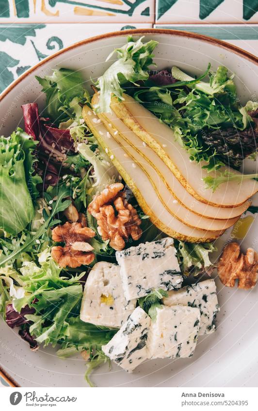 Green Salad with Pears, Blue Cheese, Walnuts Healthy Arugula Sesame Seeds Homemade Roquefort Leaf Rocket Salad Slices Fresh Piece Raw Food Nut Appetizer Vegan