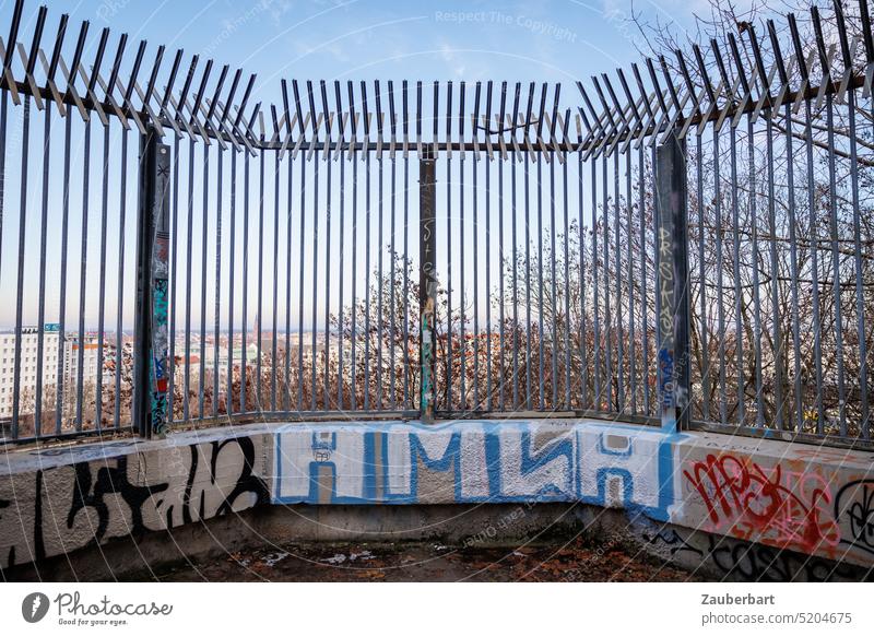 Grille for barrier on concrete base with graffiti above city Grating cordon lock Captured Concrete Pedestal Graffiti Town Tall jail obstacle overcome Fence