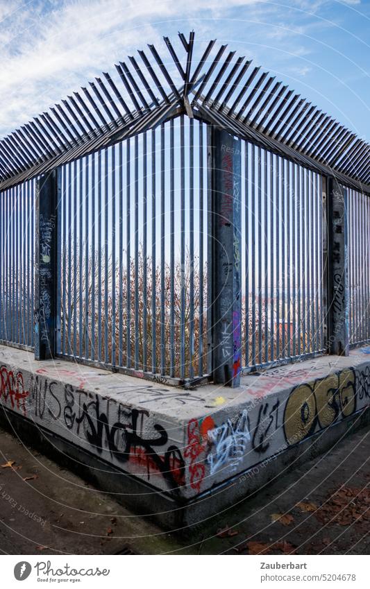 Grid at right angle to barrier on concrete pedestal with graffiti above city Grating At right angles Point Aggression peak cordon lock Captured Concrete