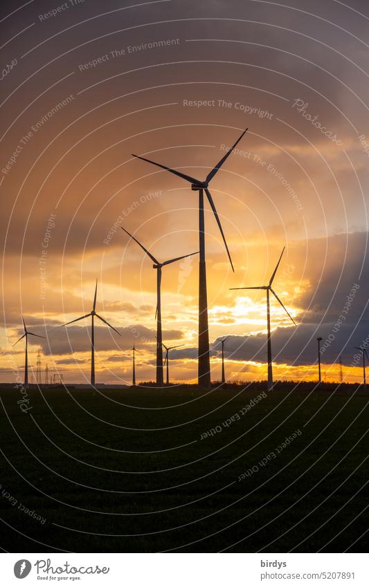 Wind turbines backlit at dusk windmills wind farm eco-power Renewable energy Energy industry Wind energy plant wind power regenerative energy Climate change