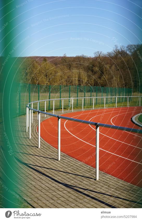 View through a green metal fence on the curve of an athletics stadium Athletics Stadium Track and Field Sports facility Running track Curve Fence Metalware