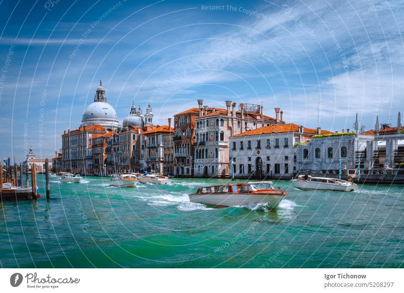 Pleasure tourist boats on Grand Canal and Basilica Santa Maria della Salute, Venice, Italy sunny cathedral venezia italy rialto europe travel landmark canal