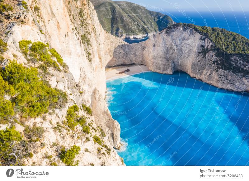 Aerial view of beautiful Navagio or Shipwreck beach on Zakynthos Island, Greece. Tourists on cliff edge enjoy view on summer travel trip island greece navagio