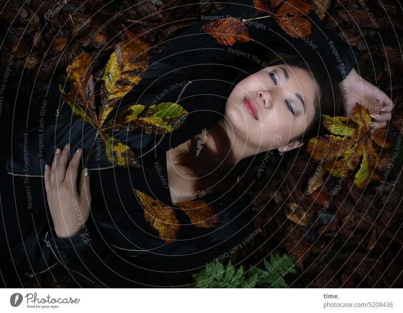 lying woman, enjoying the autumn leaves Upper body portrait Closed eyes tranquillity Bird's-eye view Deep depth of field Shadow Twilight Exterior shot Serene