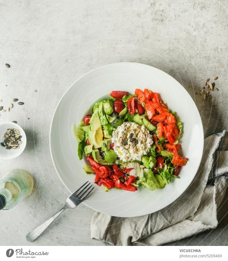 Green salad bowl with raw vegetables and cream cheese. Healthy lunch. Dieting concept green healthy lunch dieting copy space fork vitamins meal delicious tasty