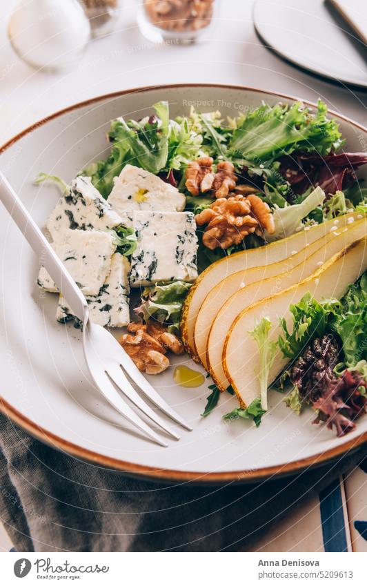 Green Salad with Pears, Blue Cheese, Walnuts Healthy Arugula Sesame Seeds Homemade Roquefort Leaf Rocket Salad Slices Fresh Piece Raw Food Nut Appetizer Vegan