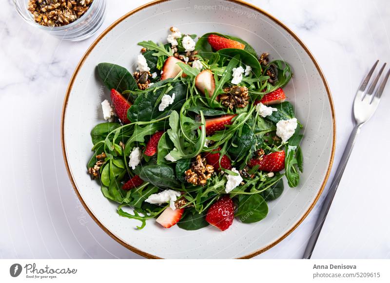 Green Salad with Strawberries, Feta Cheese, Seeds Healthy Strawberry Arugula Summer Salad Pumpkin Sesame Seeds Homemade Roquefort Leaf Rocket Salad Slices Fresh