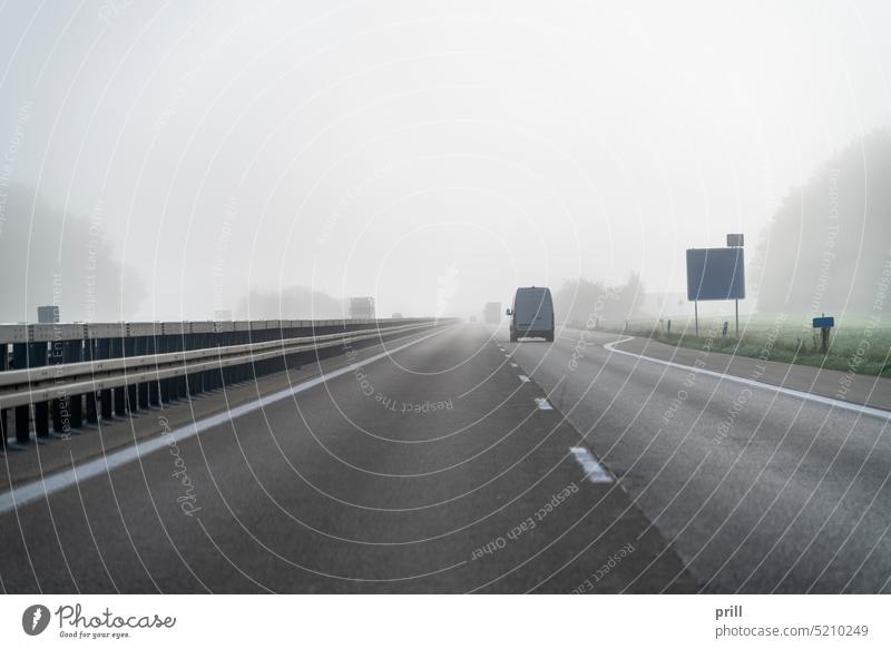 Foggy highway scenery fog controlled-access highway freeway motorway haze expressway risk traffic street road car vehicle transportation mist bad sight autumn