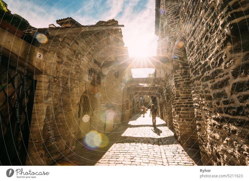 Tallinn, Estonia. People Tourists Walking In St. Catherine's Passage From St. Catherine's Dominican Monastery At Summer Day. Historic Old Town Of Tallinn. UNESCO World Heritage Site.