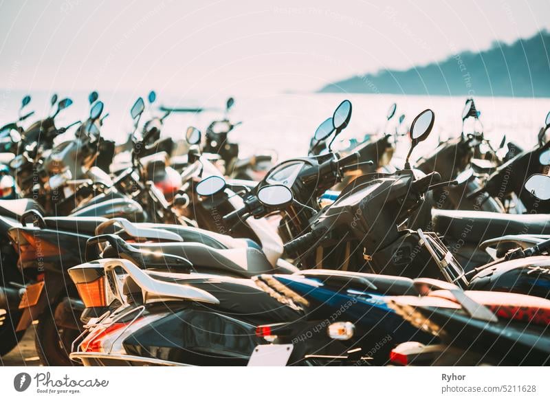 Motorbikes, motorcycles scooters parked in row in city street. Close up of details. Bikes asia asian close closeup compartment lifestyle line lot many mirror