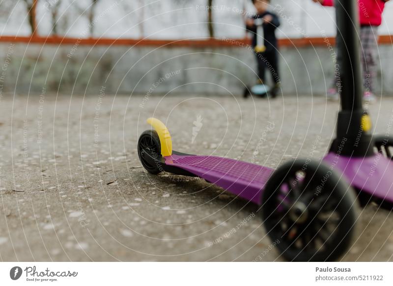 Rear view child playing with scooter scooter for children Toy Sports Child childhood Unrecognizable activity fun kid lifestyle toy leisure Park Playground cute