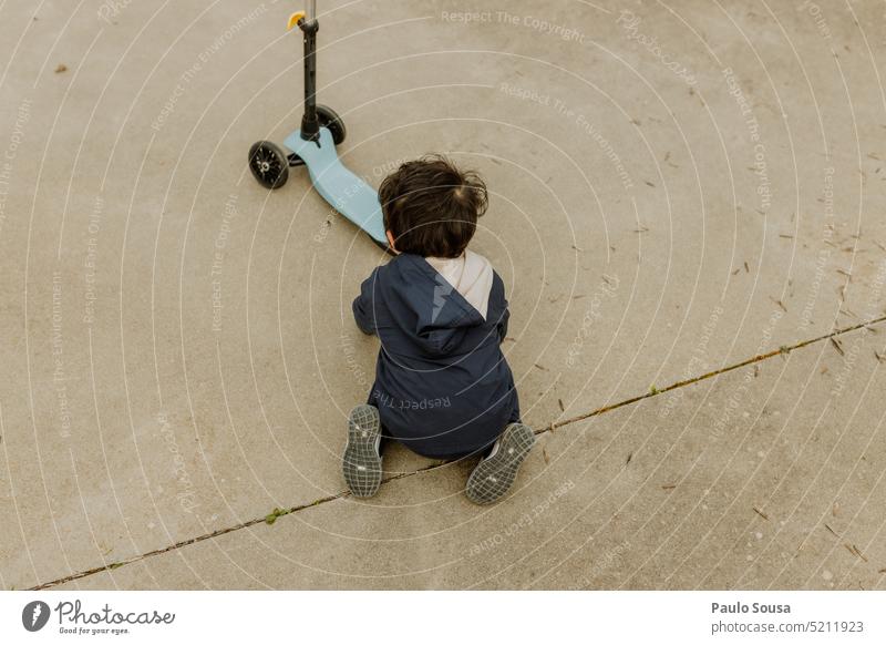 Rear view child playing with scooter scooter for children Toy Sports Child childhood Unrecognizable activity fun kid lifestyle toy leisure Park Playground cute