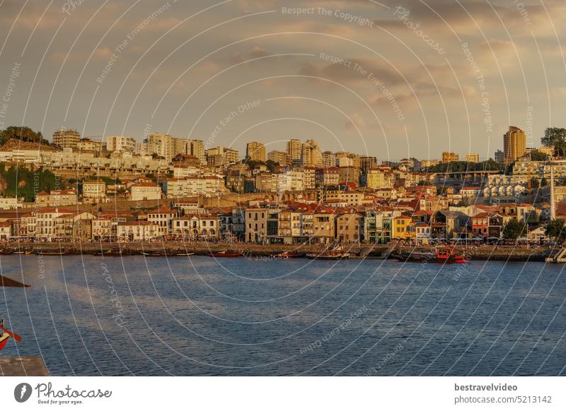 Porto (Oporto) Portugal sunset evening view of Vila Nova de Gaia area with buildings and moored ships over the Douro river. Porto sunset Oporto evening