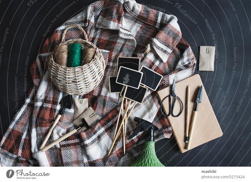 spring garden preparations. Sowing seeds. Flat lay on black background with beige shirt, tags, tools, notes. plant table agriculture vegetable farm organic