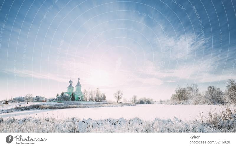 Village Krupets, Dobrush District, Gomel Region, Belarus. Old Wooden Orthodox Church Of The Holy Trinity Sunny Winter Day trinity village building architecture