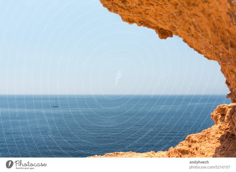 A small sailing yacht on the Mediterranean Sea near Mallorca, Spain Balearic Islands balearic Bay pretty Blue boat cala Cliff coastline Destination Europe