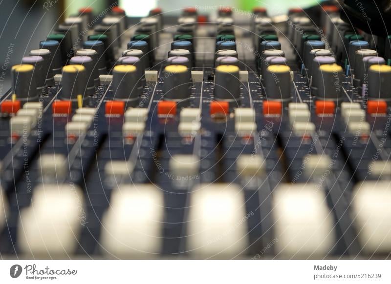 Seventies style mixer with many colorful controls for sound, disco and concert in a store in Bosch Straat in the old town of Maastricht on the Meuse River in the province of Limburg of the Netherlands