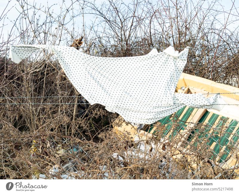 Top hangs in barbed wire fence Barbed wire Border Tracks Barrier Fence Freedom Boundary Barbed wire fence Captured garments Escape shrubby Hiding place