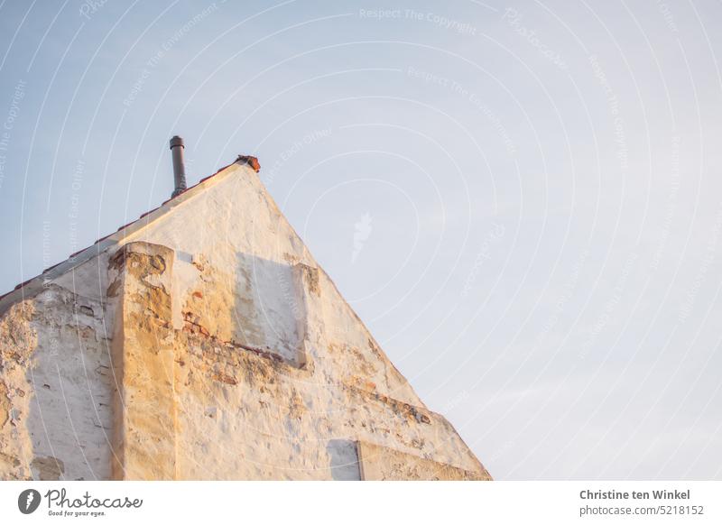 Old house facade and roof gable in evening light from | frog perspective House (Residential Structure) pediment Pointed gable Light and shadow Fire wall masonry