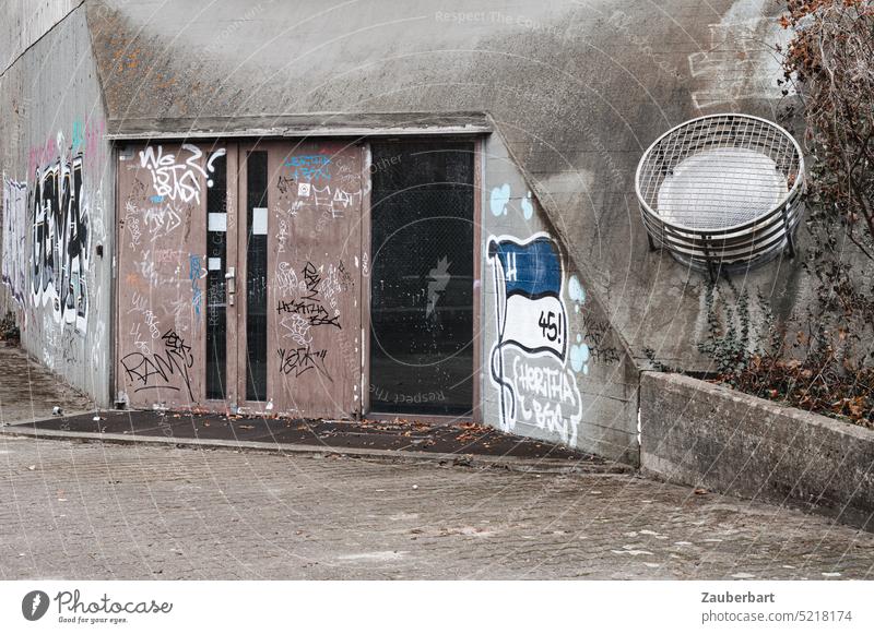 Entrance door, concrete facade, jagged line and round structure, end time and brutalism Facade Concrete research Institute Line serrated Graffiti rotten Hideous