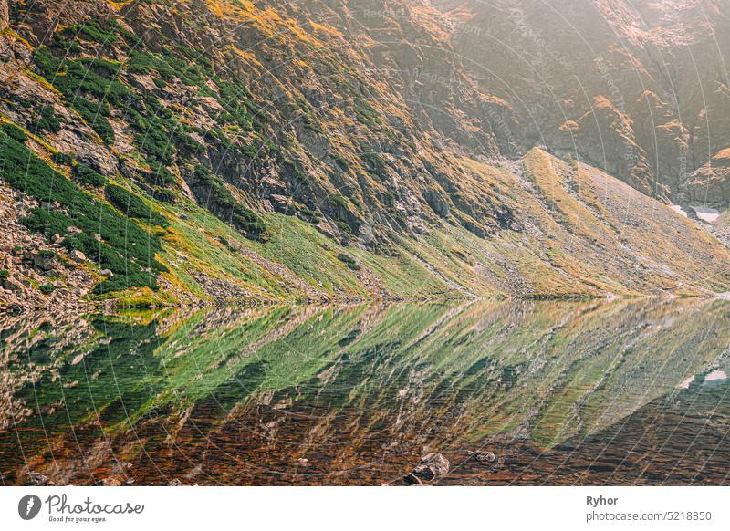 Tatra National Park, Poland. Calm Lake Czarny Staw under Rysy And Summer Mountains Landscape. Beautiful Nature, Scenic View Of Five Lakes Valley. UNESCO World Heritage Site