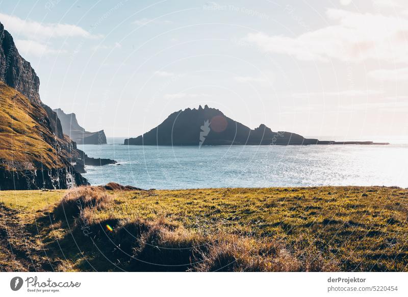 View of offshore island and fjord in sunlight II Street rocky Bad weather Environment Hill Rock highlands Rural harmony Weather Picturesque Faroe Islands