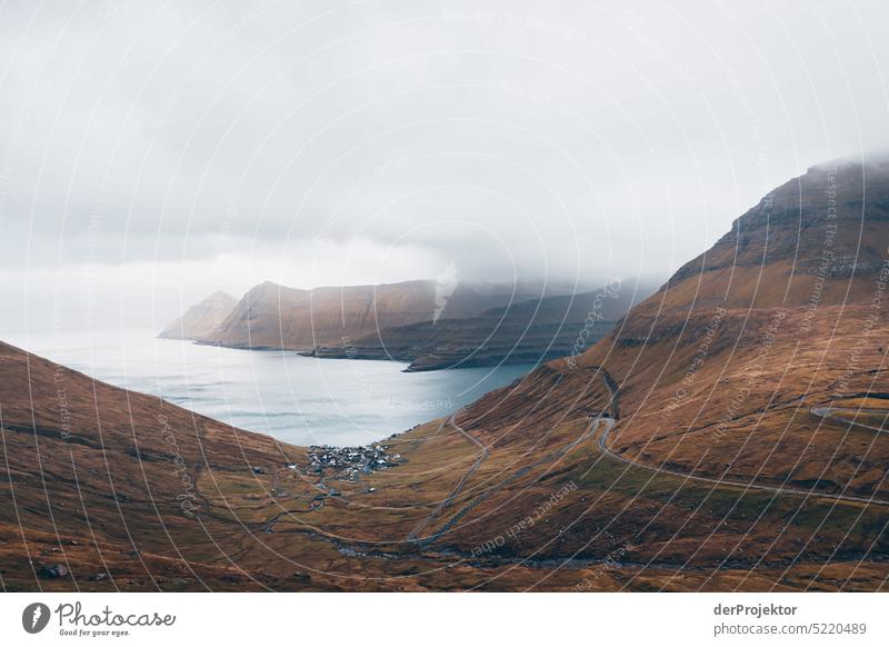 Small village with foggy landscape Street rocky Bad weather Environment Hill Rock highlands Rural harmony Weather Picturesque Faroe Islands Sunlight idyllically