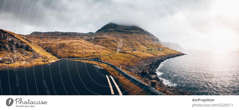 Road with view of foggy landscape Street rocky Bad weather Environment Hill Rock highlands Rural harmony Weather Picturesque Faroe Islands Sunlight idyllically