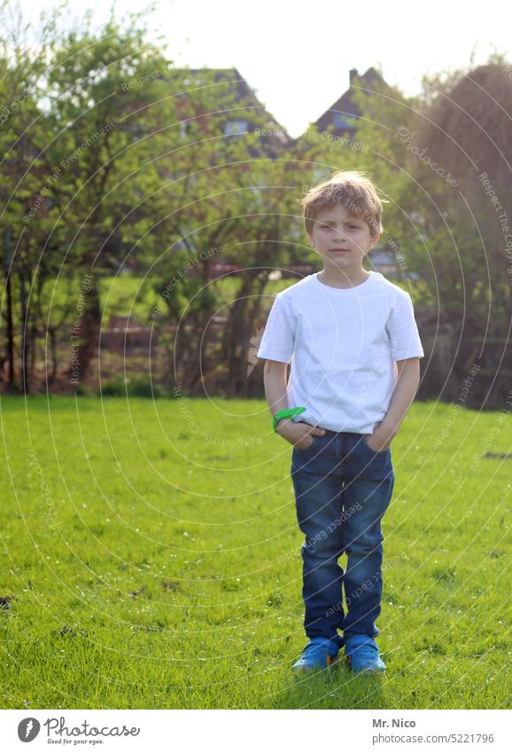 in the garden Hand-in-bag Boy (child) Self-confident Stand Posture hand in the bag Easygoing Cool (slang) portrait Fashion Hip & trendy Looking into the camera