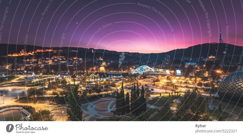 Tbilisi, Georgia. Modern Urban Night Cityscape. Evening Night Scenic View Of City Center autumn copy space night travel district center bridge fortress famous