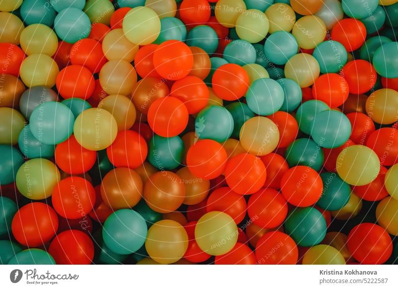 Multi-colored plastic balls in children's attraction. Funny pool, top view. active background birthday blue bright card celebration childhood colorful colour