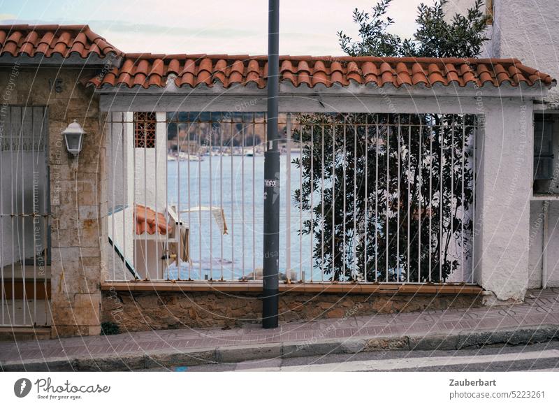 Sea view behind the bars of a covered window on the Costa Brava Ocean Looking Grating rods coast vacation Claim actuality Freedom Outbreak awakening holidays