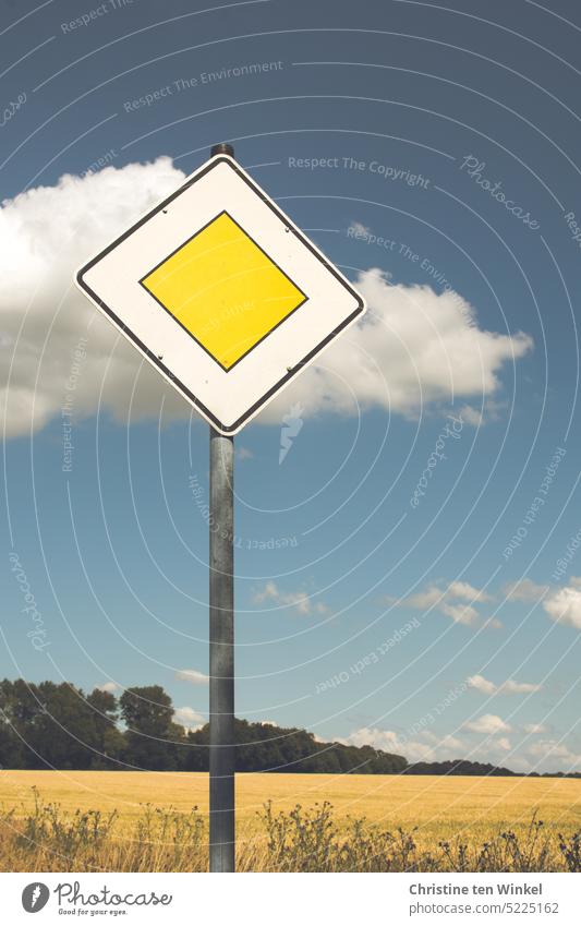 Right of way on the way to the destination right of way sign Road sign Signs and labeling Yield sign Summer Grain field Sky Clouds Edge of the forest