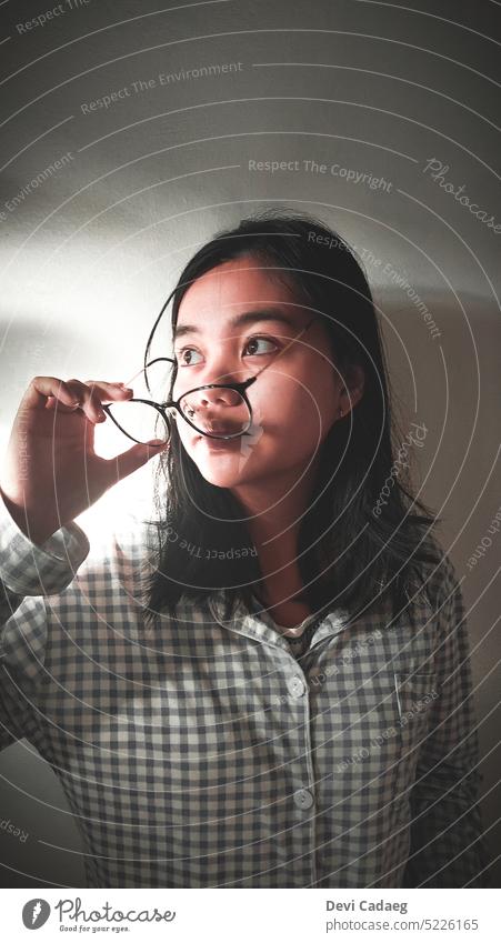 Girl putting on her glasses while looking away Portrait photograph portrait girl Black & white photo Woman Face Hair and hairstyles Youth (Young adults)