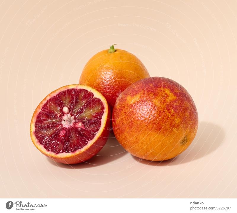 Red orange on a beige background piece raw red ripe slice sliced sweet tropical vegetarian vitamin whole circle citrus cut food fresh freshness fruit half juicy