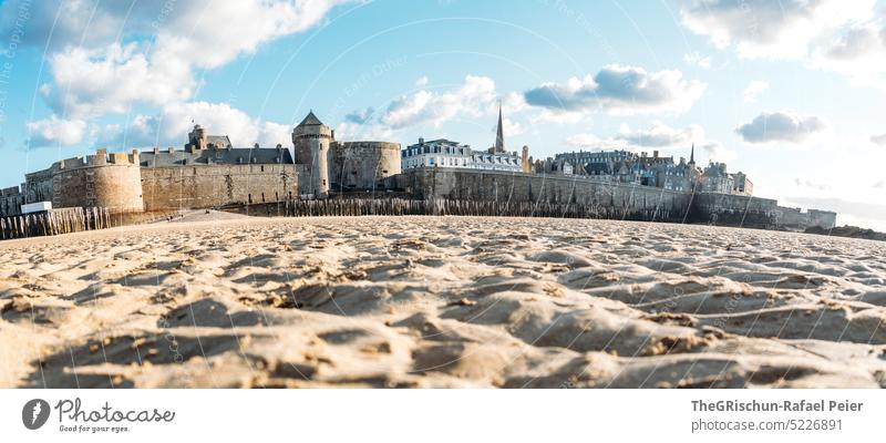 Sandy beach with houses in the background in nice weather Wall (barrier) Town France travel Tourism Brittany Vacation & Travel Landscape Exterior shot Sky