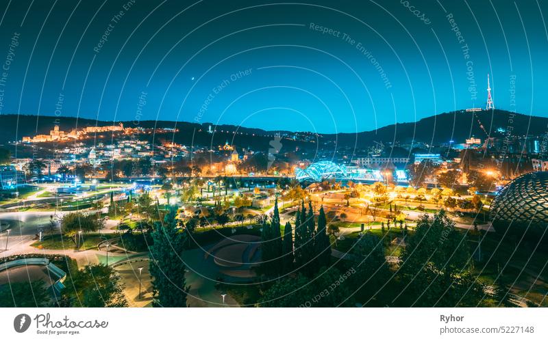 Tbilisi, Georgia. Modern Urban Night Cityscape. Evening Night Scenic View Of City Center autumn copy space night travel district Bridge of Peace center fortress