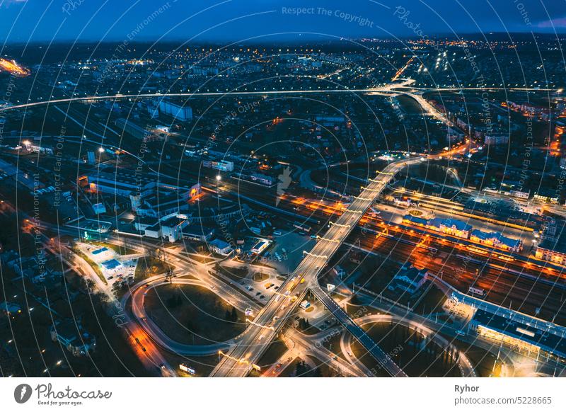 Brest, Belarus. Aerial Bird's-eye View Of Cityscape Skyline. Night Traffic In Residential District. Night Aerial View Of Railway Station. Night Aerial View Of Railway Station