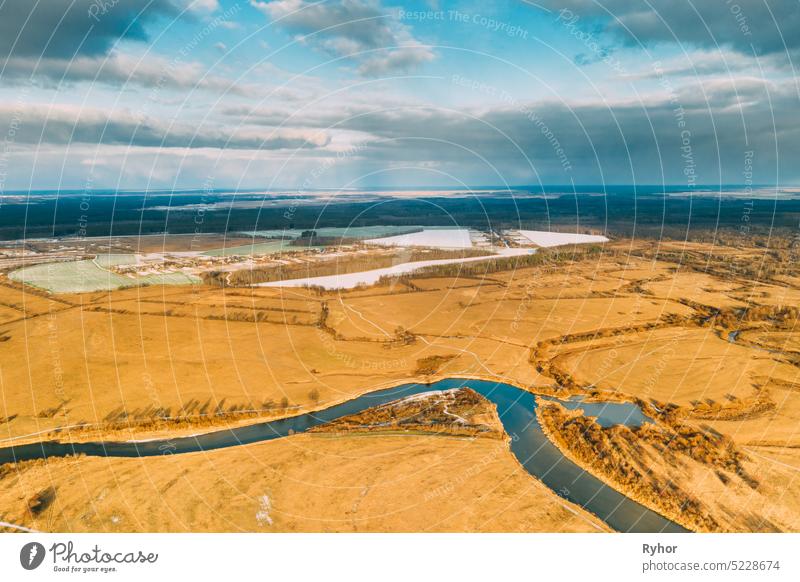 Aerial View Of Dry Grass And Partly Frozen River Landscape In Late Autumn Day. High Attitude View. Marsh Bog. Drone View. Bird's Eye View aerial aerial view